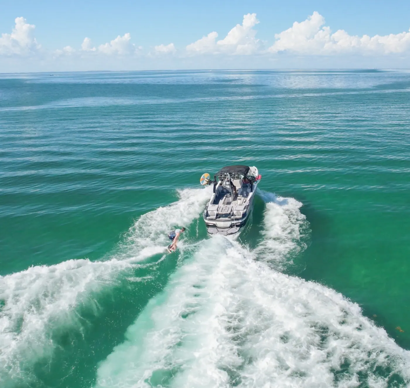 Wakesurfer riding behind the Wakehouse Miami boat on Biscayne Bay