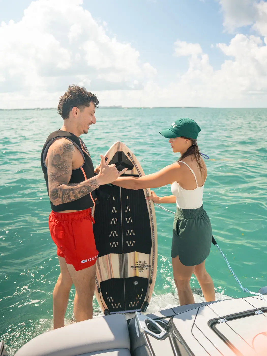 A Wakehouse Miami coach preparing a guest and wakesurf board