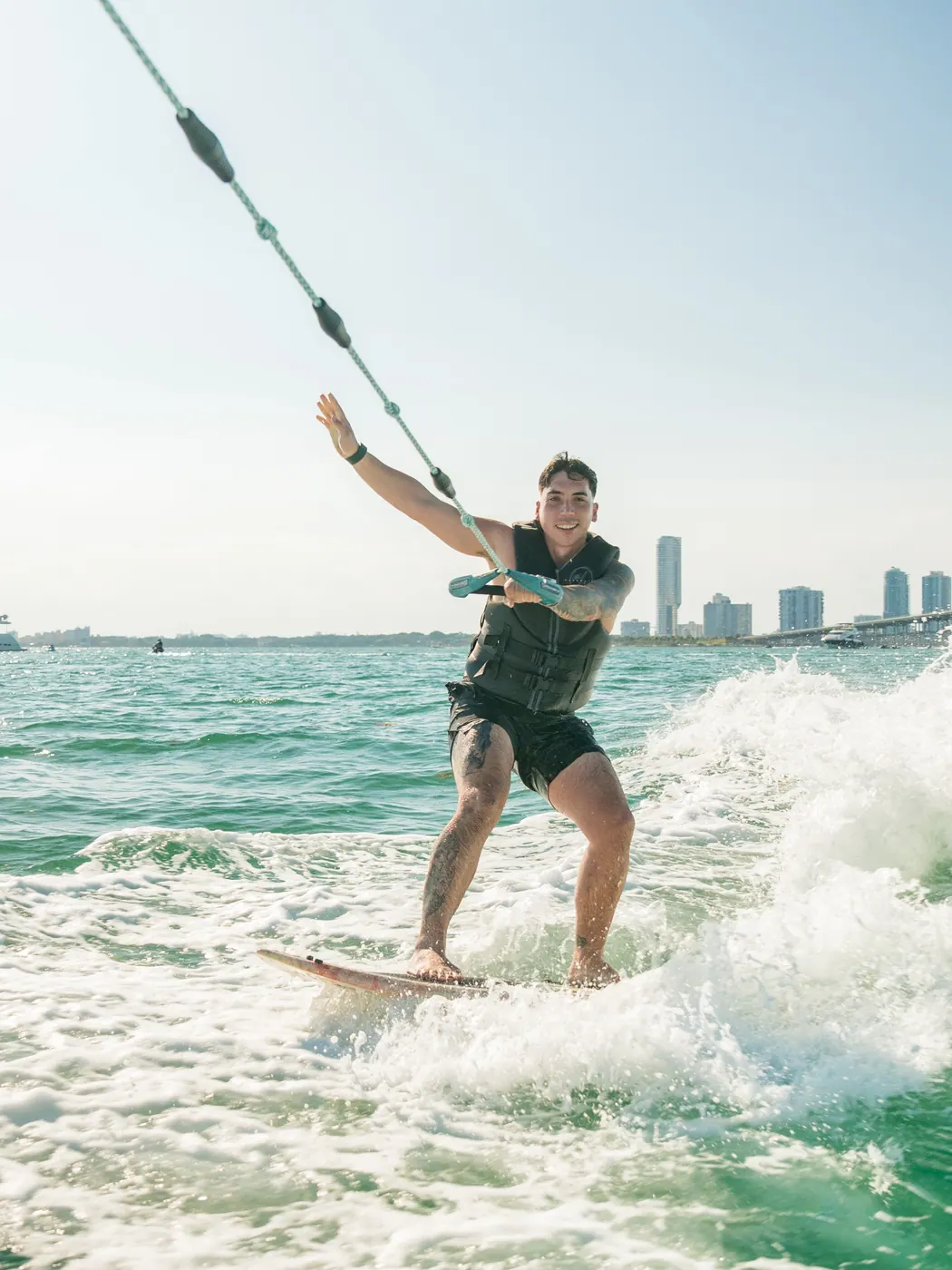 A beginner riding their first wave in Biscayne Bay