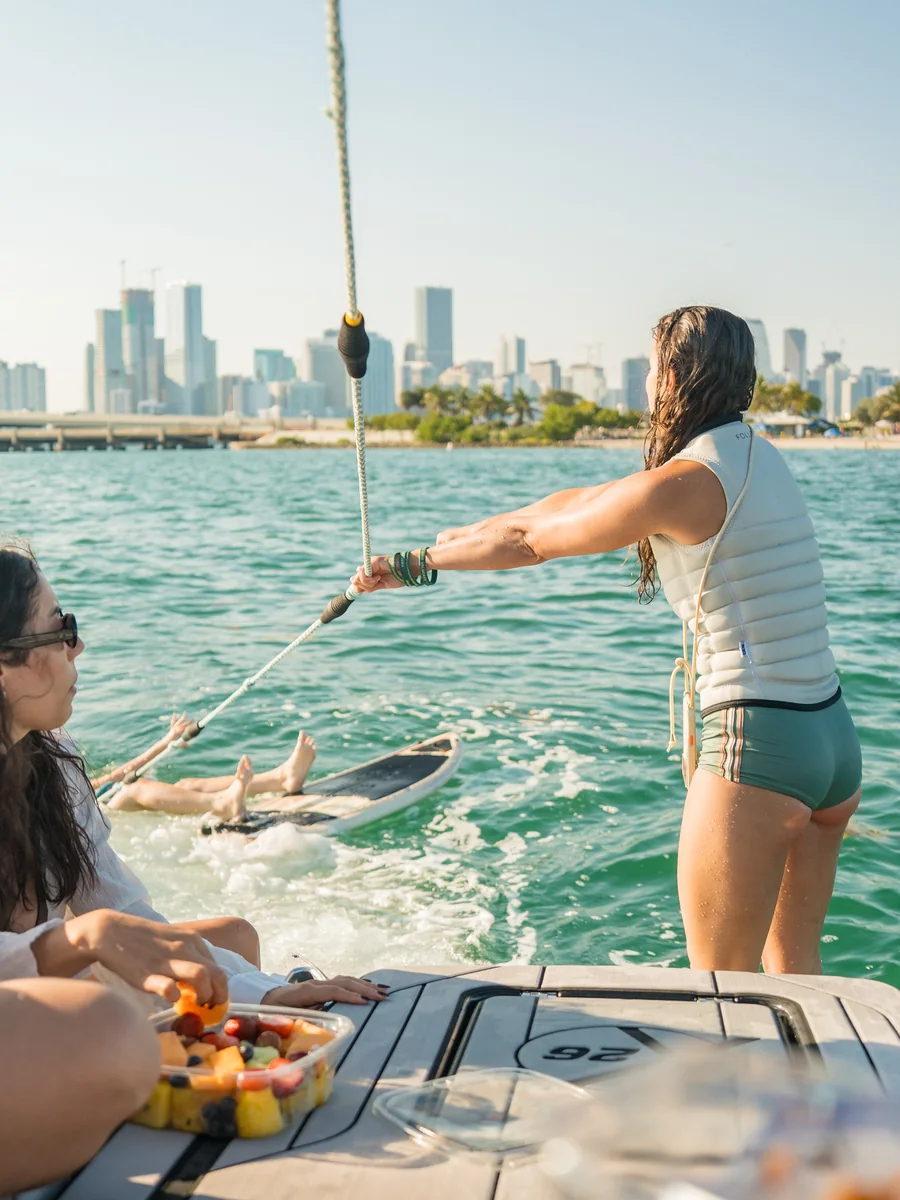 Preparing a wakesurf ride from a Wakehouse boat with the Miami skyline behind it